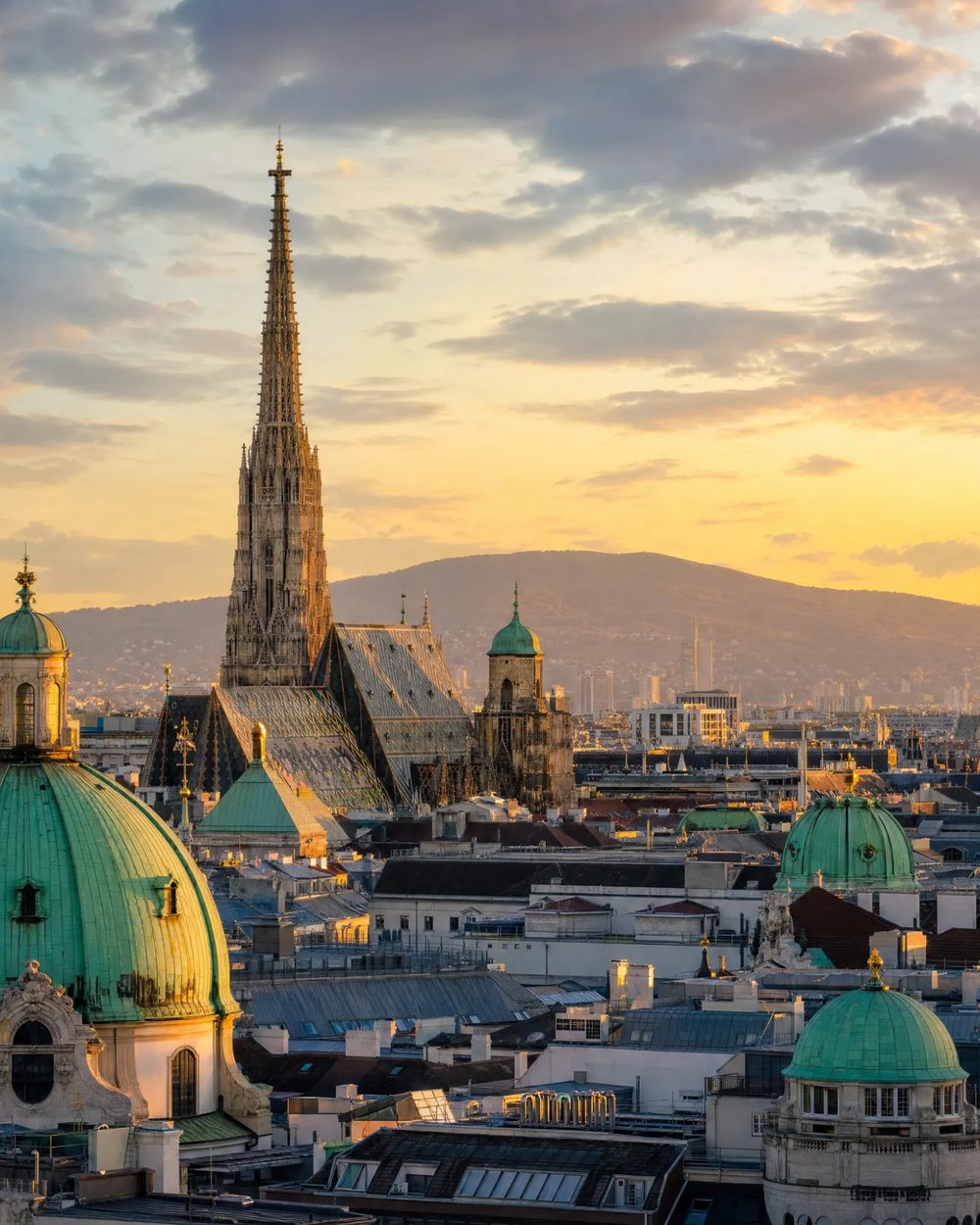 Vienna skyline with St. Stephen's Cathedral and historic rooftops at golden hour